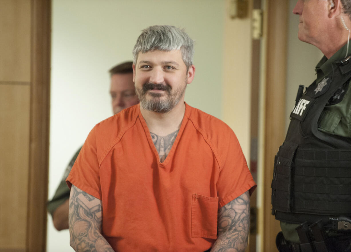 Brent Luyster, the man accused in a Woodland triple homicide, makes his way into a Clark County Superior courtroom Aug. 24. Luyster's arraignment was pushed back for a third time Tuesday.