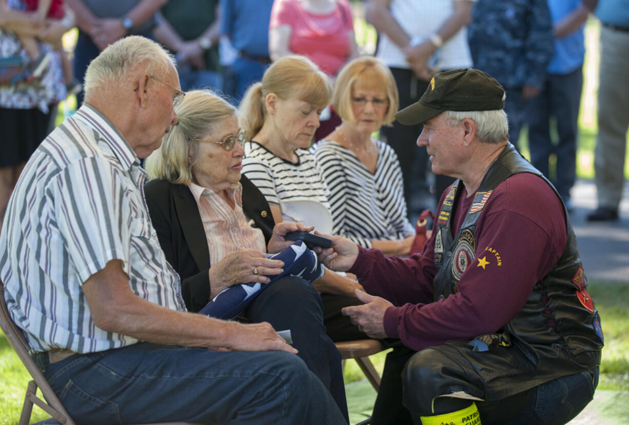 Lynn Vaughn, right, who led the Patriot Guard Riders escort Friday, talks with family members of Army Pfc. William Butz after graveside services Friday. Butz&#039;s family members are, from left, brother-in-law Gary Hein, sister Betty Hein, niece Donita Kessler and Kathy Bleth, the wife of Butz&#039;s nephew, Tom Bleth (not pictured).