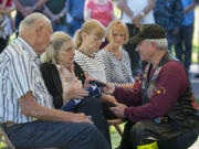 Lynn Vaughn, right, who led the Patriot Guard Riders escort Friday, talks with family members of Army Pfc. William Butz after graveside services Friday. Butz&#039;s family members are, from left, brother-in-law Gary Hein, sister Betty Hein, niece Donita Kessler and Kathy Bleth, the wife of Butz&#039;s nephew, Tom Bleth (not pictured).