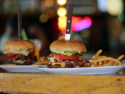 A jalape?o burger, left, and a Spot burger are served Aug. 6 at the Spot Bar &amp; Grill in Vancouver. The establishment serves those 21 and older.