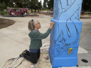 Vancouver artist Jane Degenhardt brings imagination to life while working on a mural Tuesday at Marshall Community Park Picnic Shelter. The project, which was commissioned by the Clark County Mural Society, features characters of fairy tales and folktales within the context of a Northwest landscape.