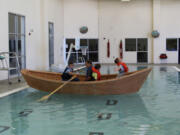 Bagley Downs: Lucas Rogers, from left, Peter Cray, Braydon Schaberg and Conner Copeland riding a boat they built during a three-week Vancouver Public Schools summer program hosted by the Wind &amp; Oar Boat School.