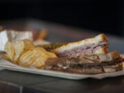 The Righteous Roast Beef panini is served Aug. 26 with chips and a pickle spear at Grapes &#039;n Growlers in east Vancouver.