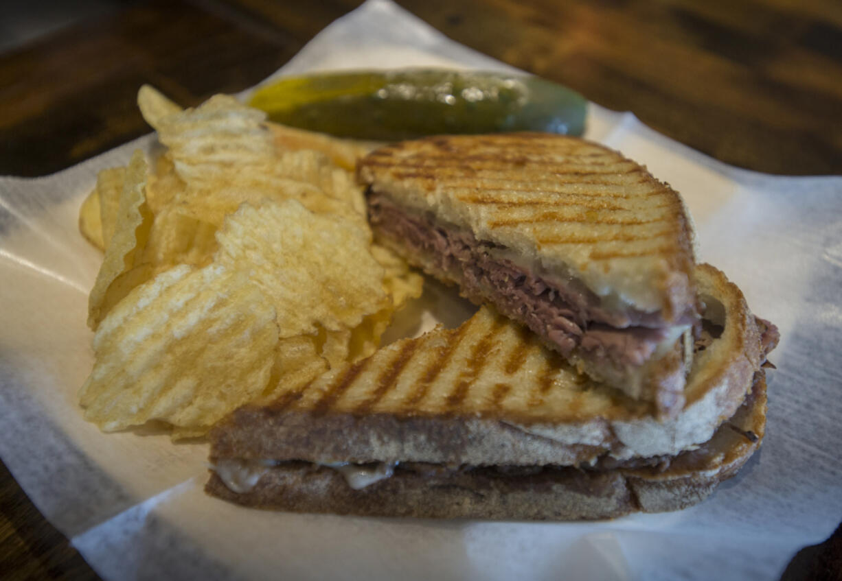 The Righteous Roast Beef panini is served Aug. 26 with chips and a pickle spear at Grapes &#039;n Growlers in east Vancouver.