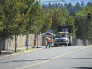 Dean Felts of Allcon Construction LLC works on a C-Tran bus stop Wednesday at Northeast 162nd Avenue and 78th Street in Vancouver. The work is part of a large service change the agency is undergoing.