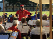 Felida: Vancouver Community Concert Band Director Jim Rourk leads the volunteer ensemble in a performance at the Vintage Base Ball game at the Fort Vancouver National Site.