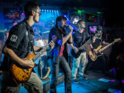 DnD7 rocks the Sunday night Youth Jam at Billy Blues Bar and Grill. The eye of drummer Chase Colson is at far left, peeking over the shoulder of lead guitarist Jonny Wilson; singer Chance Duitman; guitarist Trevor Short; and bass player Ethan Short.