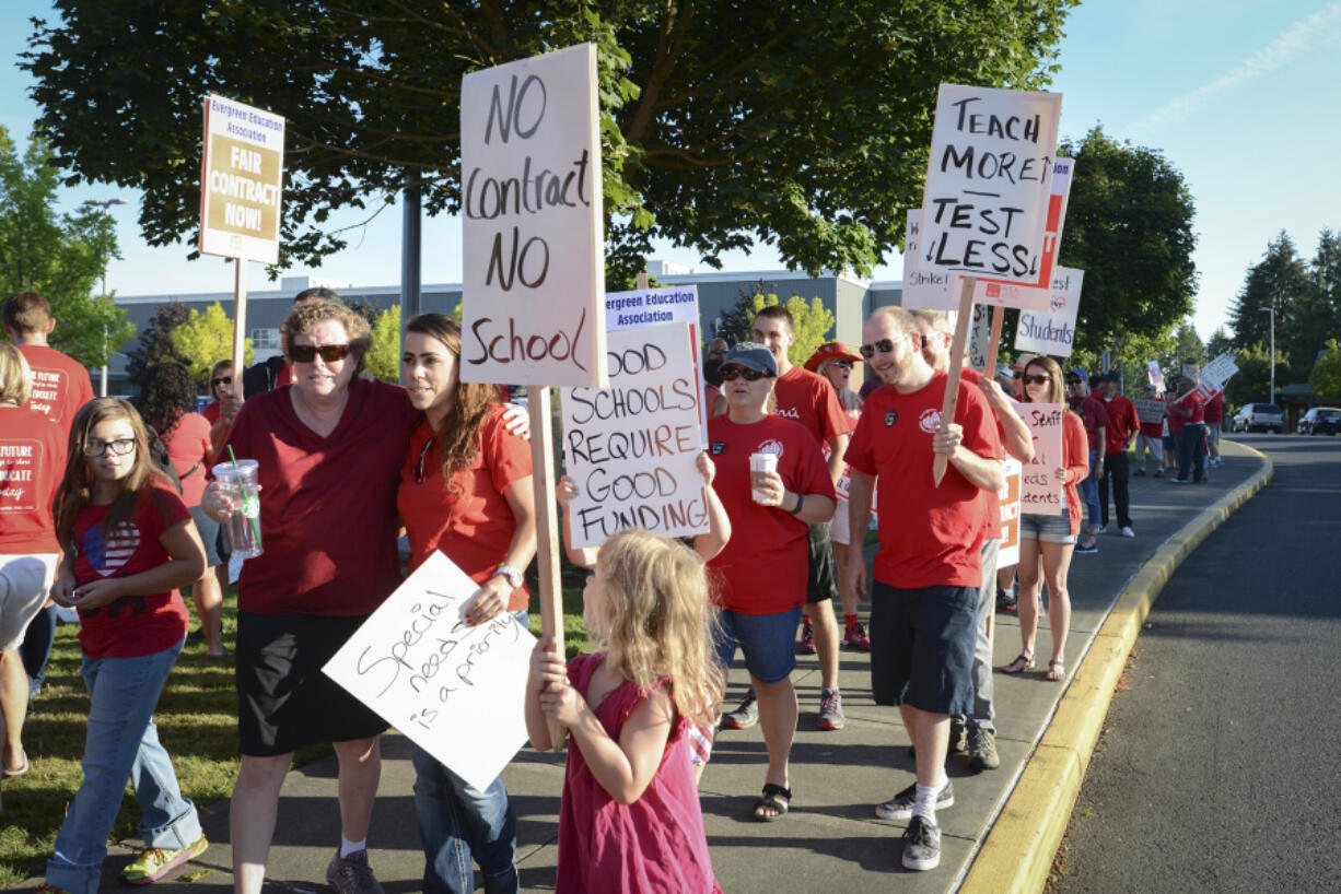 Teachers and community members picket Friday at Evergreen High School amid contract negotiations.