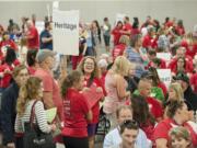 Dozens of teachers fill the Clark County Event Center as they hold signs representing their schools before the start of the meeting Tuesday evening, Aug. 30, 2016.