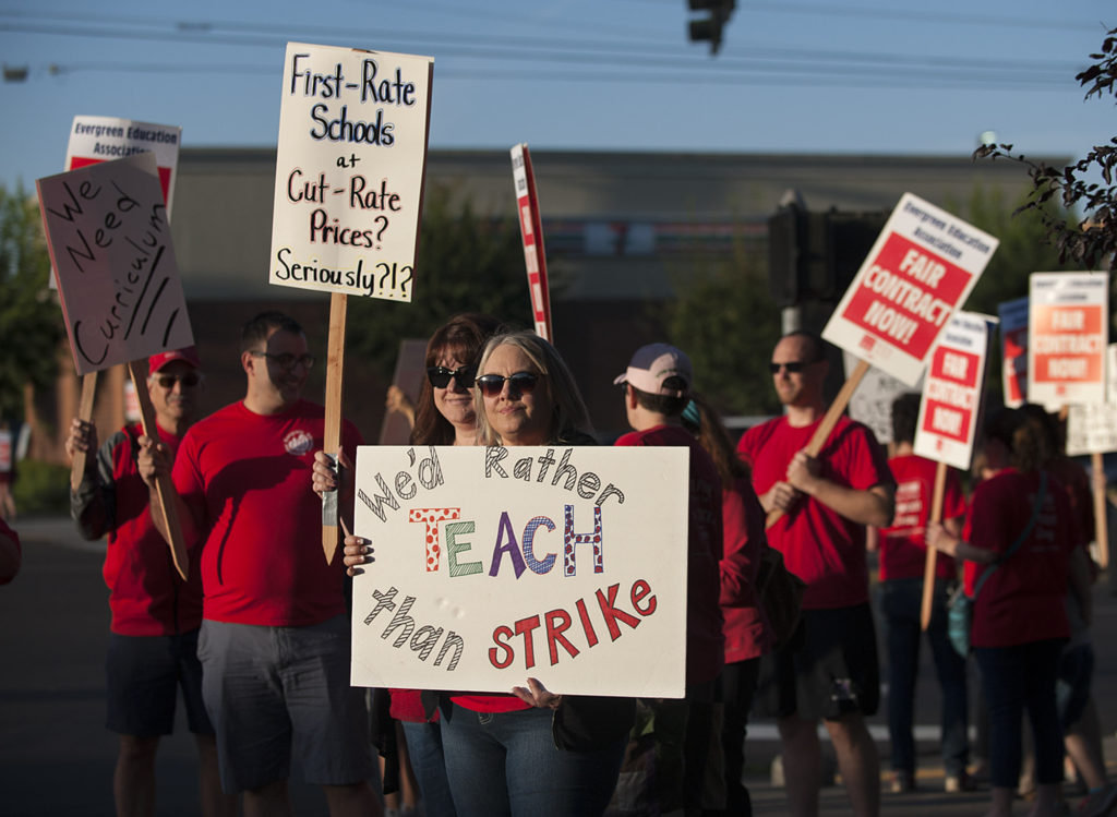 Teacher librarians Kristie Peak of Mill Plain Elementary School, foreground, and Beth Pfenning of Hearthwood Elementary School join picketers Friday morning, Aug. 19, 2016 in Southeast Vancouver.