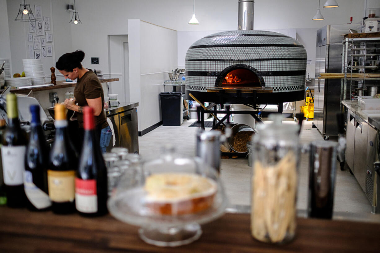 Sara Collins preps food in the kitchen at the newly opened Nonavo Pizza in downtown Vancouver.