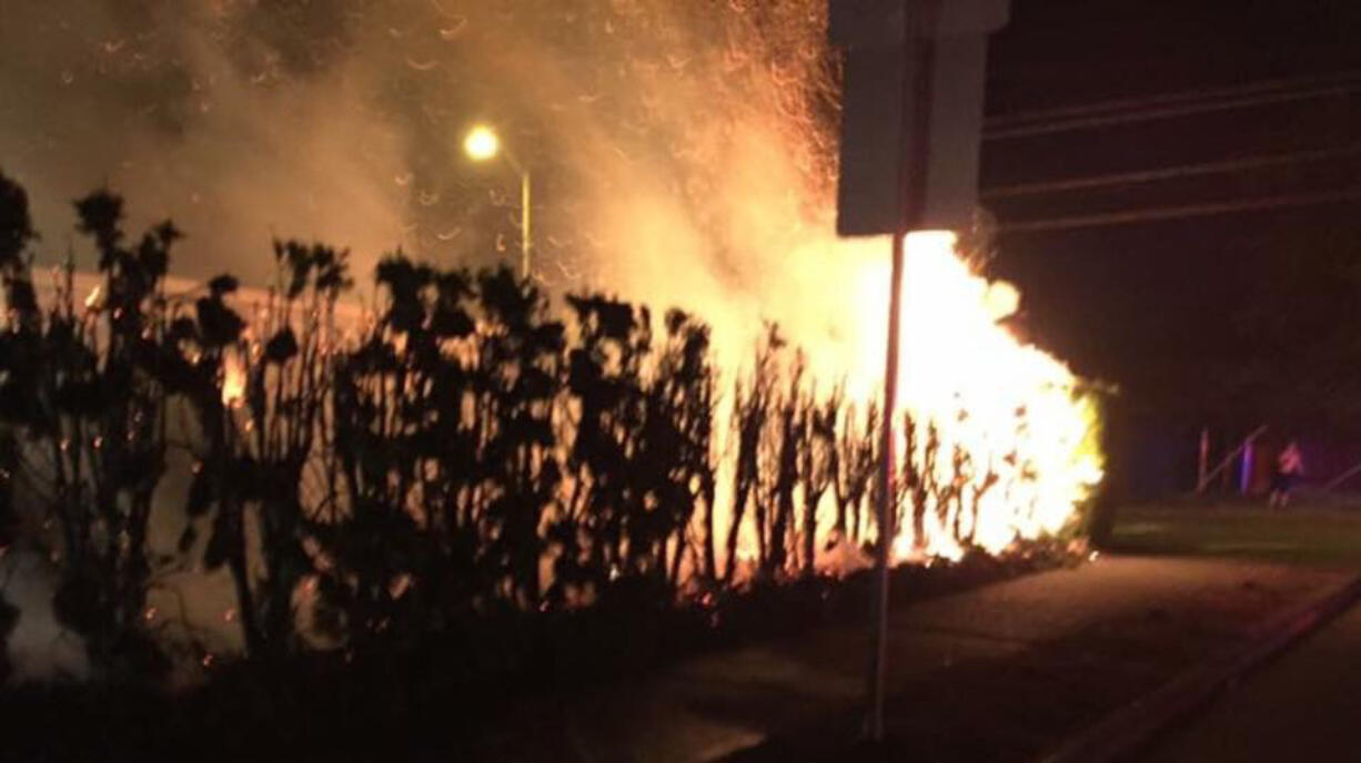 A fire burns in a Vancouver Heights home's landscaping Thursday night. The fire, sparked by fireworks, did about $20,000 in damage to the home.