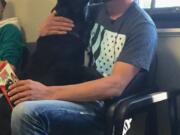 Battle Ground's William Jones greets his black Lab, Hunter, Tuesday, weeks after the dog had run away then was mistakenly adopted out to another family while Jones was away for work.