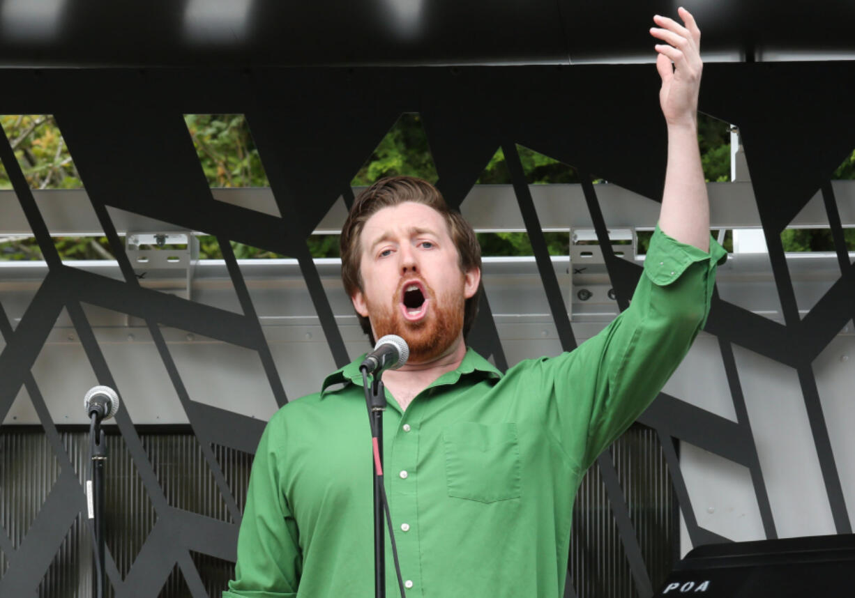 Zachary Lenox of the Portland Opera sings &quot;Toreador&quot; from &quot;Carmen&quot; during an Opera a la Cart performance at the Vancouver Farmers Market on Saturday. Opera a la Cart, a mobile venue, is a play on the Pacific Northwest&#039;s food truck scene.