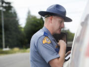 Washington State Patrol Trooper Will Finn talks to a driver he pulled over on suspicion of using a cellphone while driving. The traffic stop was part of a sting on Interstate 5 last month that targeted distracted drivers.