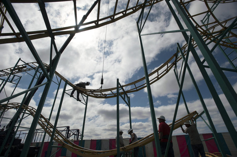 Juan Losano of Butler Amusement, top, works with colleagues as they assemble a roller coaster for the upcoming Clark County Fair on Wednesday morning, Aug. 3, 2016 at the Clark County Fairgrounds.