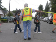 Children walk on their way to the first day of classes at Washington Elementary School in 2014 with help from Mick Hawthorn and other walking school bus volunteers.
