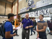 Heritage High School Principal Derek Garrison helps sophomores Anton Tikhonov, left, and Maksim Trukhlinskiy with their schedules Wednesday on the first day of class in Evergreen Public Schools.