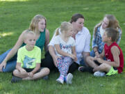 Christie BrownSilva, center, and her children, pictured near Heritage High School, were relieved Monday to hear that Evergreen Public Schools and its union had reached a tentative contract agreement after 14 months of bargaining. BrownSilva&#039;s five children, Toby, 7, from left in shark T-shirt, Jaymie, 13, Paige, 5, Madison, 15, and Kenny, 9, are starting at schools in the district Wednesday.