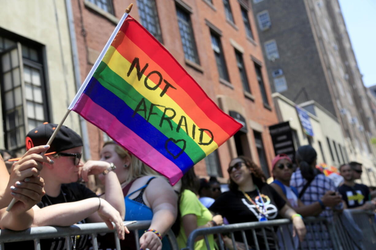 A woman holds a rainbow flag during the NYC Pride Parade in New York on June 26, 2016. Young Americans overwhelmingly say they support LGBT rights when it comes to employment, health care and adoption. That's according to a new GenForward survey, which finds 92 percent of young adults support HIV and AIDs prevention, 90 percent support equal employment, and 80 percent support LGBT adoption. Across ethnic groups, large majorities of Americans aged 18 to 30 favor training police on transgender issues, government support for LGBT youth organizations and insurance coverage for transgender health issues.