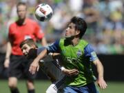 Seattle Sounders midfielder Nicolas Lodeiro, right, battles for the ball with Los Angeles Galaxy forward Steven Gerrard, left, in the second half of an MLS soccer match, Sunday, July 31, 2016, in Seattle. (AP Photo/Ted S.