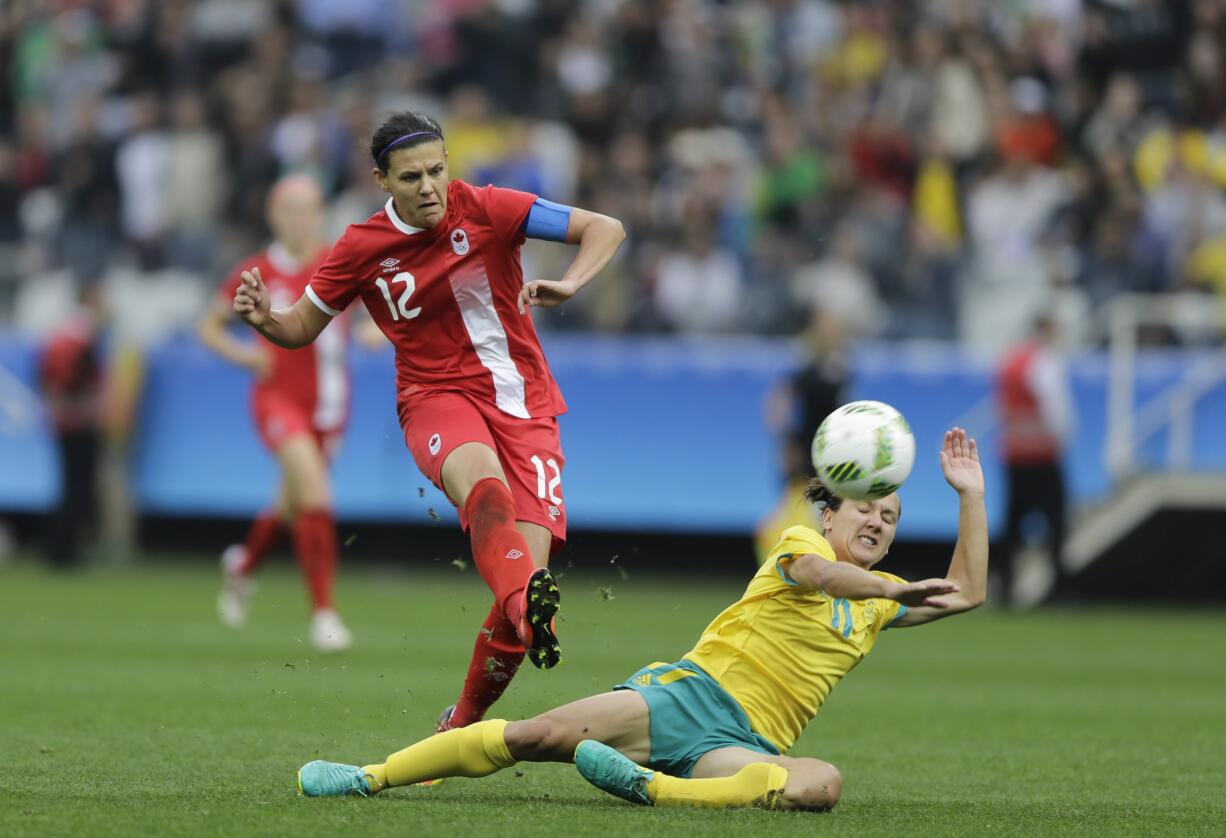 Canada's Christine Sinclair, left, scores her team's 2nd goal, during the 2016 Summer Olympics football match between Canada and Australia, at the Arena Corinthians, in Sao Paulo, Brazil, Wednesday, Aug. 3, 2016. Canada won 2-0.