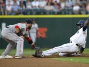 Seattle Mariners' Guillermo Heredia, right, is tagged out by Boston Red Sox second baseman Dustin Pedroia as Heredia tried to steal during the third inning of a baseball game, Thursday, Aug. 4, 2016, in Seattle. (AP Photo/Ted S.