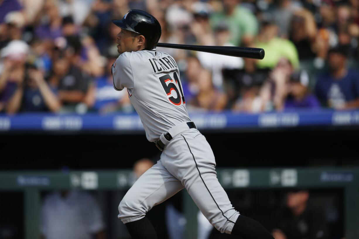 Miami Marlins' Ichiro Suzuki follows the flight of his triple off Colorado Rockies starting pitcher Chris Rusin in the seventh inning of a baseball game, Sunday, Aug. 7, 2016 in Denver. The hit was the 3,000th in his Major League career.