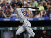 Miami Marlins' Ichiro Suzuki follows the flight of his triple off Colorado Rockies starting pitcher Chris Rusin in the seventh inning of a baseball game, Sunday, Aug. 7, 2016 in Denver. The hit was the 3,000th in his Major League career.