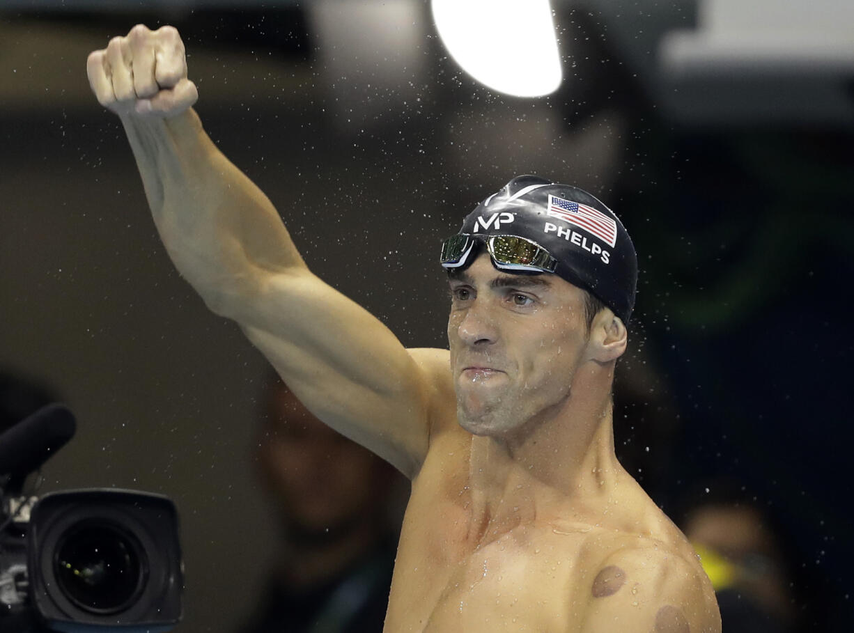 United States' Michael Phelps celebrates after winning the gold medal during the swimming competitions at the 2016 Summer Olympics, Tuesday, Aug. 9, 2016, in Rio de Janeiro, Brazil.