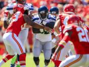 Kansas City Chiefs linebacker Ramik Wilson (53) tries to tackle Seattle Seahawks running back Christine Michael (32) during the first half of an NFL preseason football game in Kansas City, Mo., Saturday, Aug. 13, 2016.