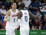 United States' Klay Thompson (11) celebrates with teammate Kyrie Irving (10) after making a basket during a basketball game against France at the 2016 Summer Olympics in Rio de Janeiro, Brazil, Sunday, Aug. 14, 2016.