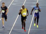 Usain Bolt from Jamaica, center, wins the gold medal in the men's 200-meter final during the athletics competitions of the 2016 Summer Olympics at the Olympic stadium in Rio de Janeiro, Brazil, Thursday, Aug. 18, 2016.