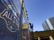 A worker attaches a banner to a scaffolding in New Orleans in preparation of the 2014 NBA All-Star basketball game. The NBA has decided to hold the 2017 All-Star Game in New Orleans, a person familiar with the decision told The Associated Press. The person spoke to the AP on condition of anonymity Friday, Aug. 19, 2016, because the decision hasn't been announced. New Orleans replaces Charlotte, which was set to host the game until the NBA decided last month that it wouldn't hold its marquee, mid-season event in North Carolina because of a state law that limits anti-discrimination protections for lesbian, gay and transgender people.