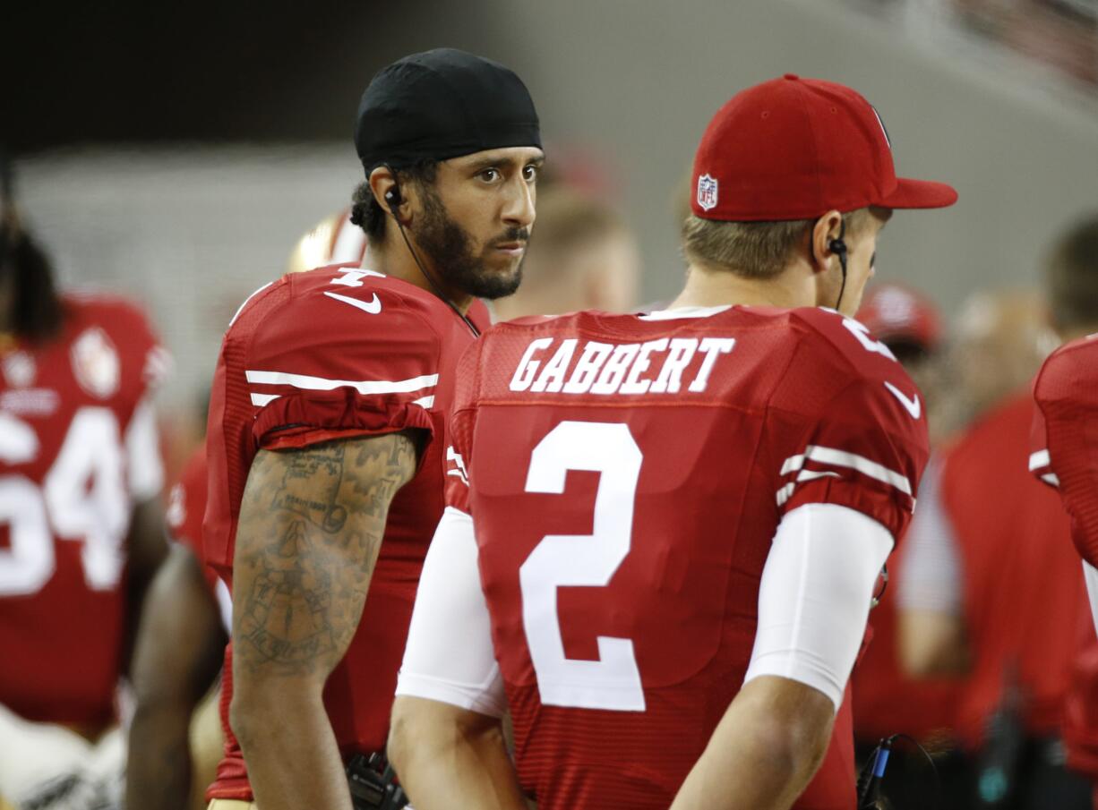 San Francisco 49ers quarterbacks Colin Kaepernick, left, and Blaine Gabbert stand on the sideline during the second half of an NFL preseason football game against the Green Bay Packers on Friday, Aug. 26, 2016, in Santa Clara, Calif. Green Bay won 21-10.