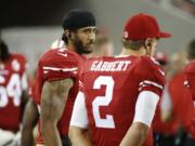 San Francisco 49ers quarterbacks Colin Kaepernick, left, and Blaine Gabbert stand on the sideline during the second half of an NFL preseason football game against the Green Bay Packers on Friday, Aug. 26, 2016, in Santa Clara, Calif. Green Bay won 21-10.