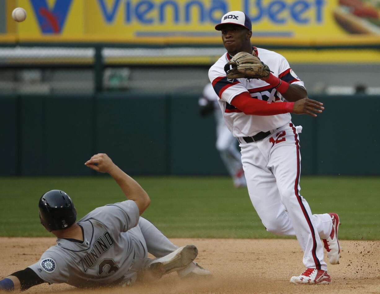 Chicago White Sox shortstop Tim Anderson, right, throws out Seattle Mariners' Adam Lind at first base after forcing out Mike Zunino, left, at second base during the seventh inning of a baseball game in Chicago, Sunday, Aug. 28, 2016. (AP Photo/Nam Y.