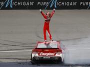 Kyle Larson celebrates winning the NASCAR Sprint Cup Series auto race at Michigan International Speedway, in Brooklyn, Mich., Sunday, Aug. 28, 2016.