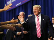 Republican presidential candidate Donald Trump greets the crowd as he arrives to speak at a campaign rally in Fredericksburg, Va., on Saturday.