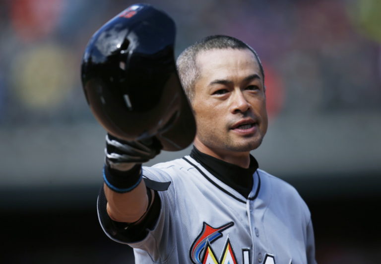 Miami Marlins' Ichiro Suzuki tips his batting helmet to the crowd as fans applaud after he hit a triple off Colorado Rockies relief pitcher Chris Rusin in the seventh inning of a baseball game, Sunday, Aug. 7, 2016 in Denver. The hit was the 3,000th in his Major League career.