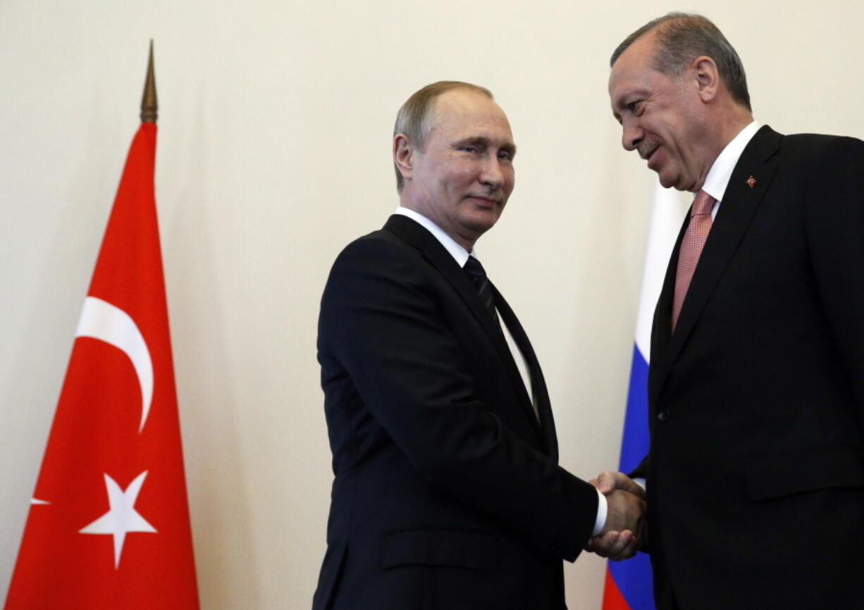 Russian President Vladimir Putin, left, welcomes Turkish President Recep Tayyip Erdogan in the Konstantin palace outside St.Petersburg, Russia, on Tuesday. President Erdogan travels to Russia to meet with President Putin for the first time since apologizing in late June for the downing of a Russian fighter jet along the Syrian border in November last year.