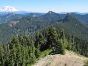 From the summit of Badger Peak, hikers get a view of the peaks and rocks of the Dark Divide roadless area, plus can see Mount Adams on the eastern horizon.