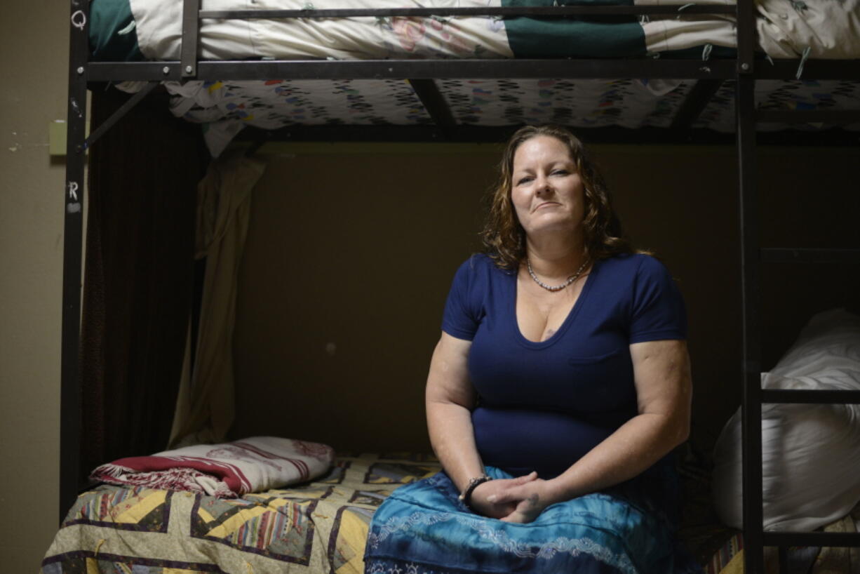 Susan Contreras sits on her bed in a Phoenix-area shelter for victims of domestic violence on Wednesday, Aug. 3, 2016. Contreras is part of a unique program at the Barrow Neurological Institute in Phoenix that aims to assist abuse survivors who have suffered head trauma.