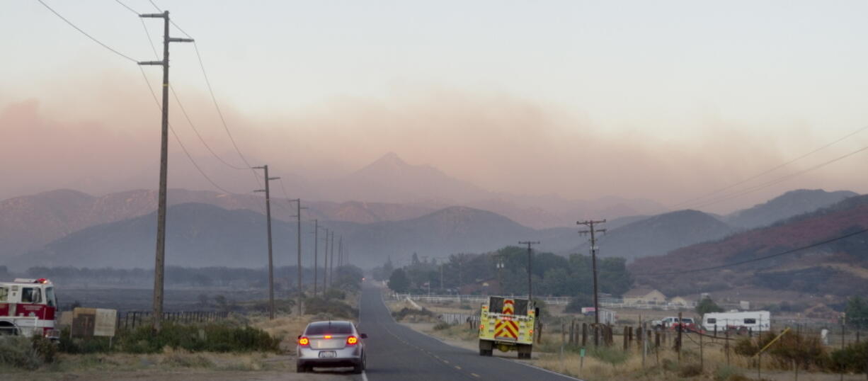 A wildfire burns in late evening Monday in Hesperia Calif. Smoke plumes roiling from flaming ridges of the San Bernardino Mountains blew all the way across the Mojave Desert to Las Vegas as California&#039;s latest big wildfire chewed through timber and brush Monday. Hundreds of firefighters, aided by 16 aircraft, battled flames that spread across 7 square miles on the northern side of the rugged mountain range about 60 miles east of Los Angeles.