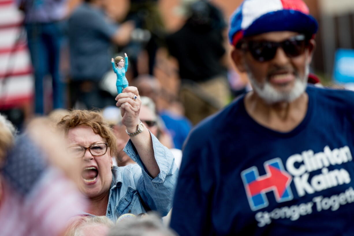 Members of the audience cheer as Democratic presidential candidate Hillary Clinton and Democratic vice presidential candidate, Sen. Tim Kaine, D-Va., hold a rally at Fort Hayes Metropolitan Education Center in Columbus, Ohio, Sunday, July 31, 2016. Clinton and Kaine are on a three-day bus tour through the rust belt.