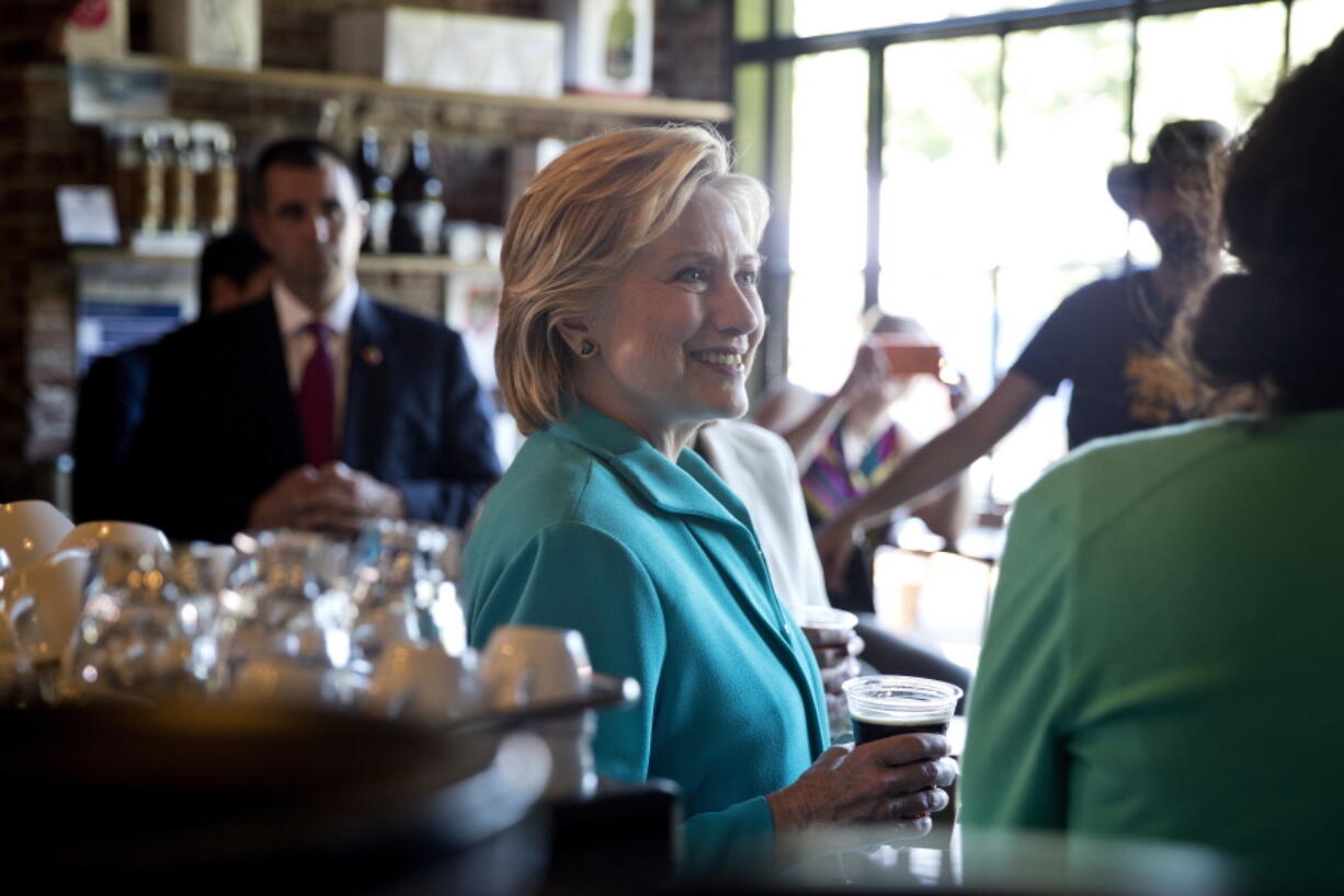 Democratic presidential candidate Hillary Clinton visits with patrons and supporters at Hub Coffee Roasters in Reno, Nev., on Thursday.