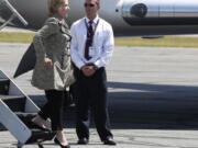 Democratic presidential candidate Hillary Clinton steps from her campaign plane as she arrives at Nantucket Memorial Airport in Nantucket, Mass., on Saturday en route to a fundraiser.