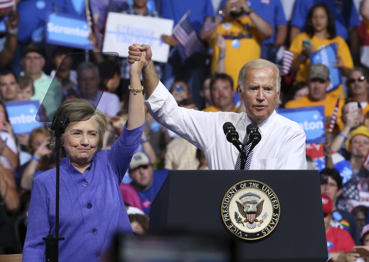 Democratic presidential candidate Hillary Clinton and Vice President Joe Biden hold hands in the air during a campaign rally, Monday, Aug. 15, 2016, in Scranton, Pa.