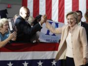 Democratic presidential candidate Hillary Clinton is greeted as she arrives at a campaign event at John Marshall High School in Cleveland, Wednesday, Aug. 17, 2016.