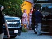 Democratic presidential candidate Hillary Clinton, center left, leaves the home of Marcia Riklis, center right, following a private fundraiser in Southampton, N.Y., Sunday, Aug. 28, 2016.